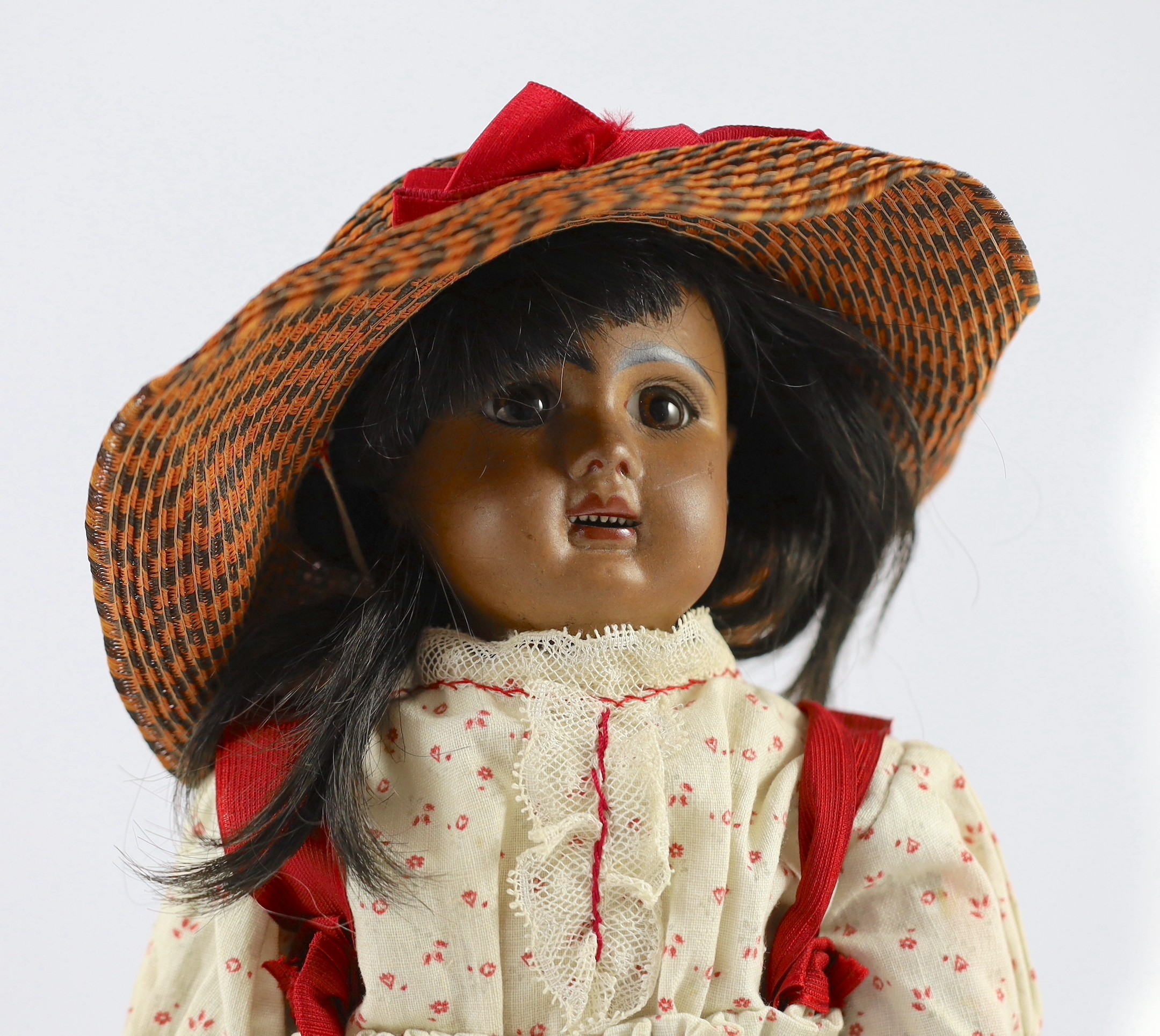 A Jules Steiner Mulatto bisque doll, French, circa 1890, 17in.